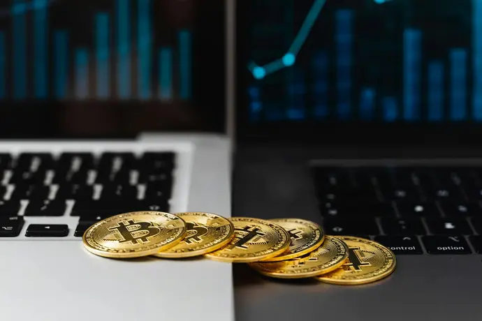 Bitcoin and laptop used for crypto tax record review
